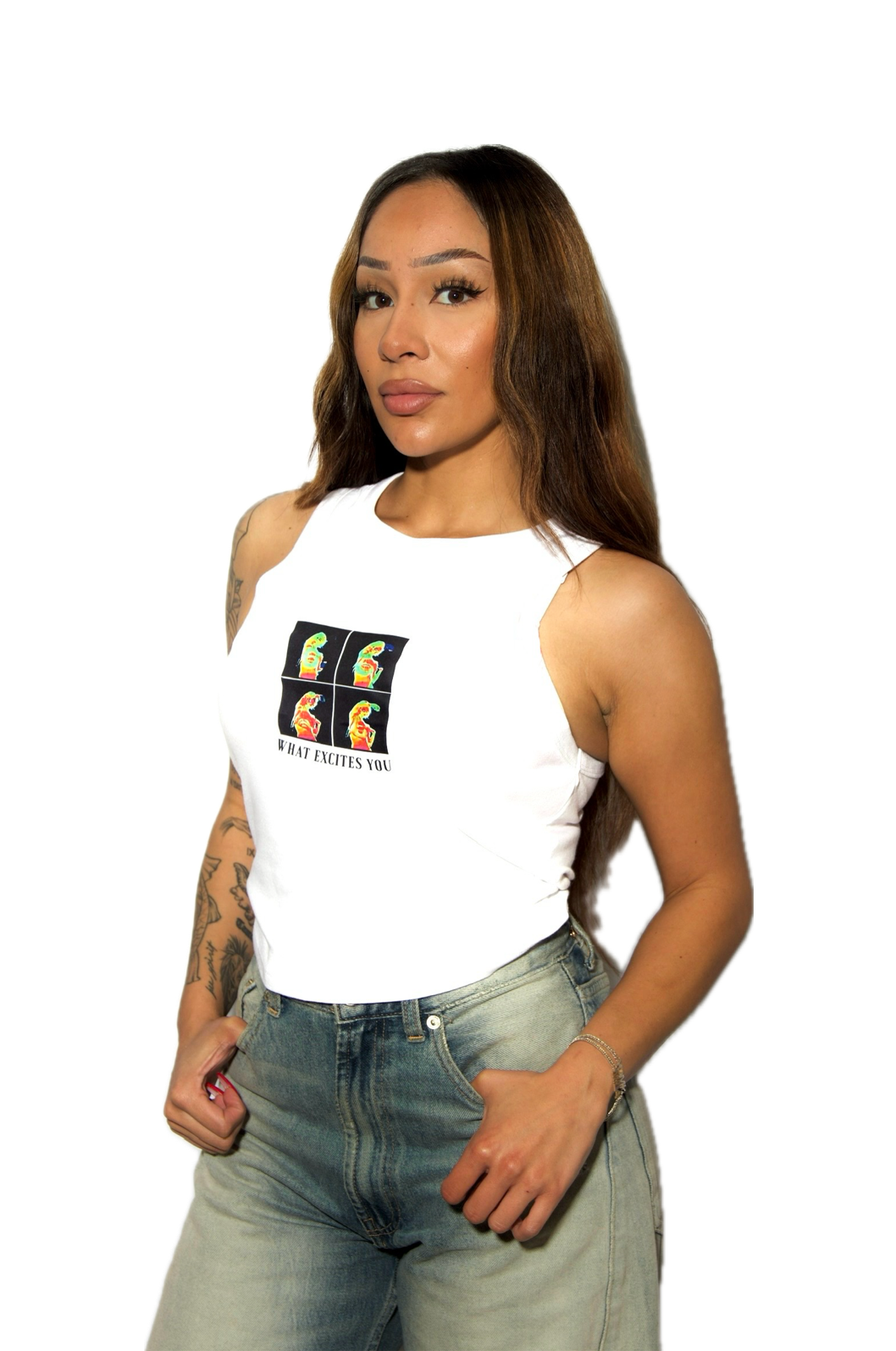 Woman wearing a white tank top with a colorful graphic and text, paired with light blue jeans on a white background.