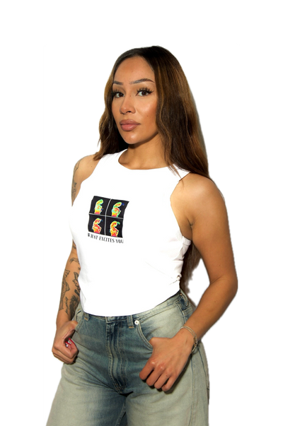 Woman wearing a white tank top with a colorful graphic and text, paired with light blue jeans on a white background.