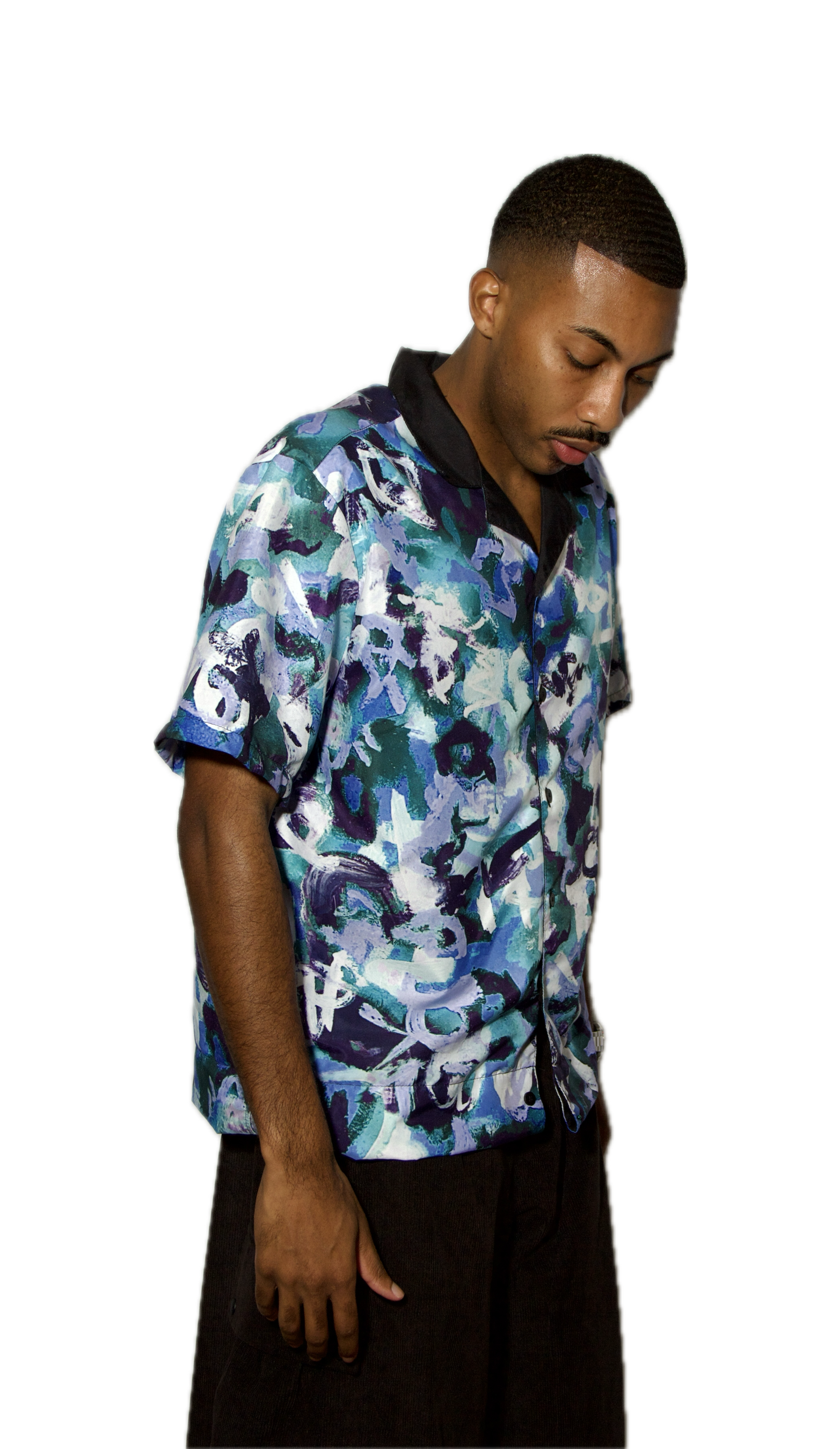 Man wearing a colorful floral shirt on a white background