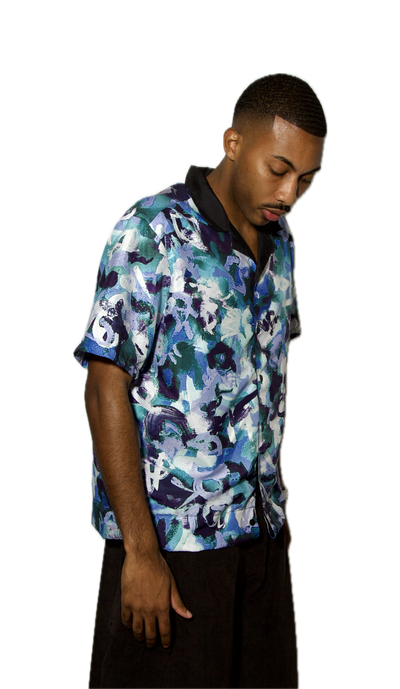 Man wearing a colorful floral shirt on a white background