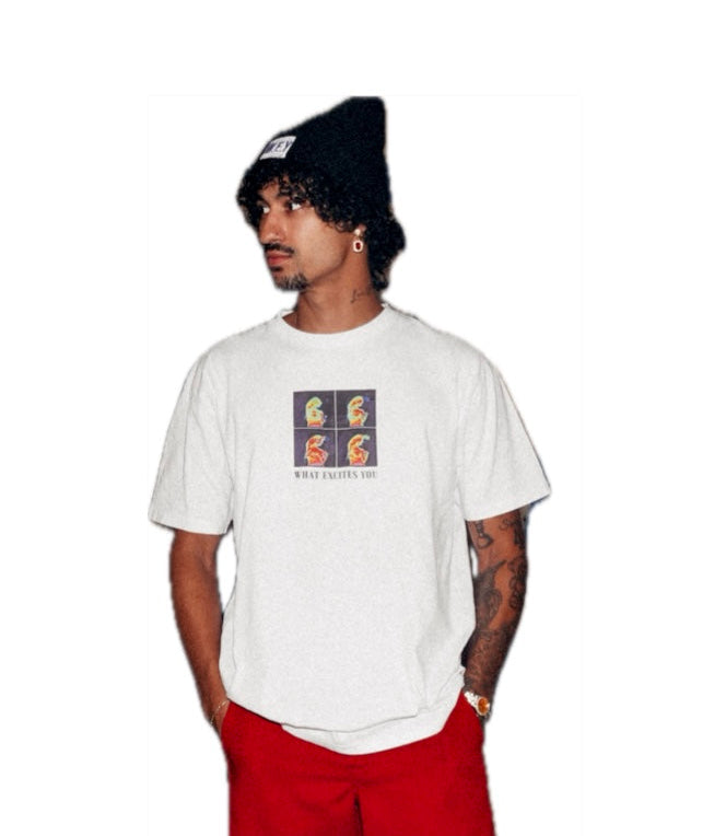 Person wearing a white t-shirt with a graphic design, red pants, and a black beanie on a white background