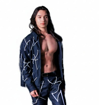 Person wearing a black outfit with white designs, holding balloons on a white background