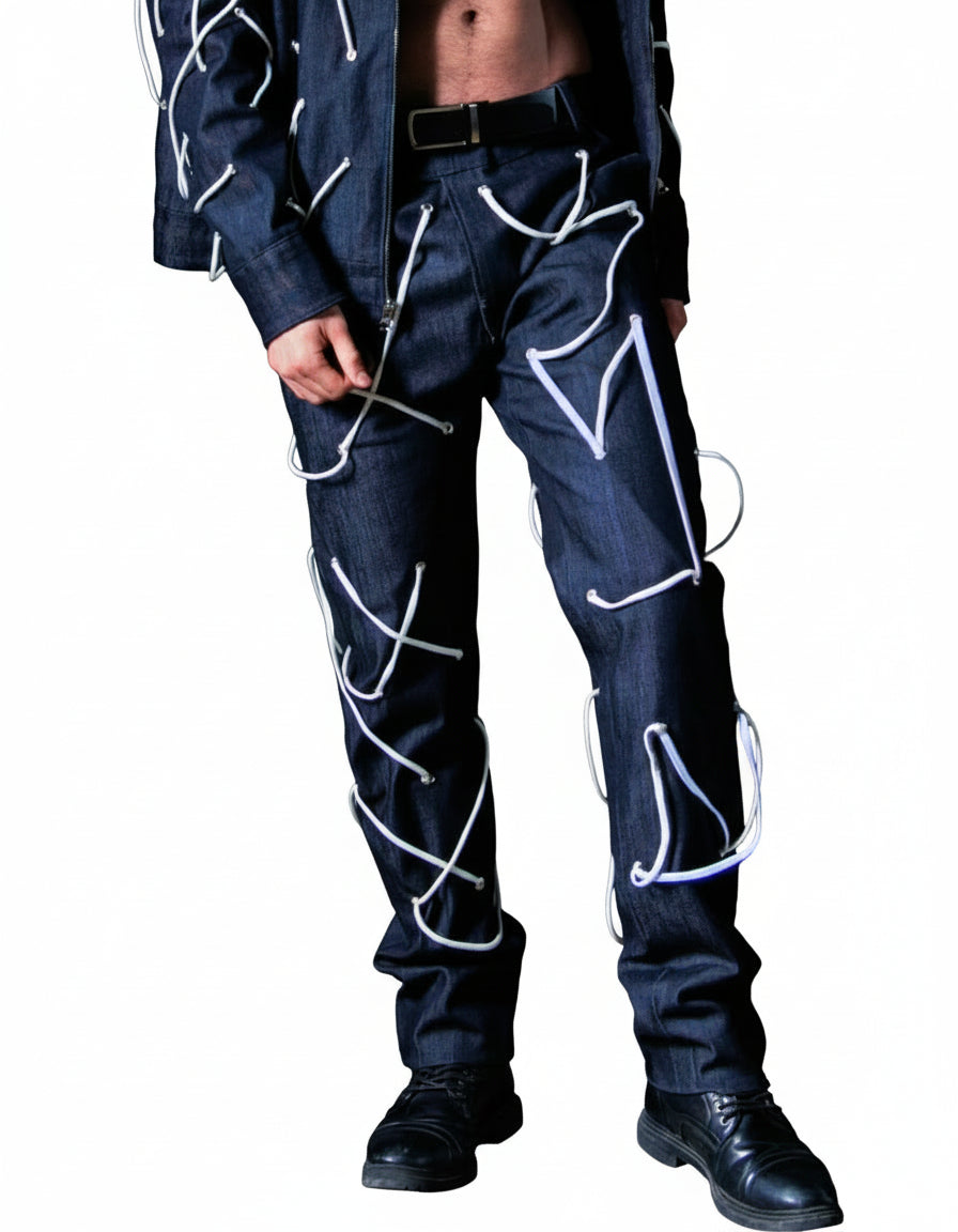 Person wearing a dark suit with white geometric patterns in an indoor setting.